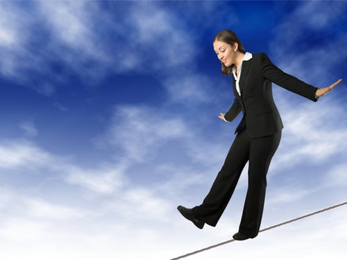 Business woman balancing on rope